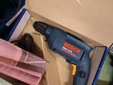a box with a drill in it sitting on a table