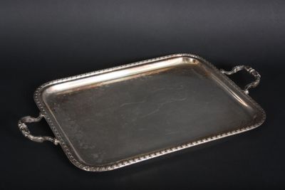 a silver tray with handles and handles on a black surface