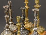 a wooden table with a bunch of silver candles on it