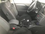 the interior of a small car with a steering control and a center console