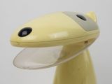 a close up of a yellow object on a white surface