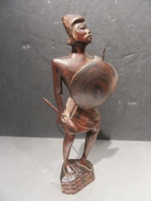 statue of a man holding a shield and a shield in his hand