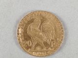 a close up of a gold coin on a white surface