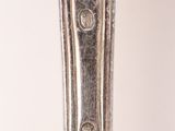 an image of a silver spoon on a table with a white background