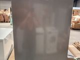 an image of a stainless steel refrigerator in a warehouse