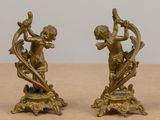 pair of antique bronze figurines of cupid playing with bow and arrow