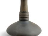 a black vase that is sitting on a white surface