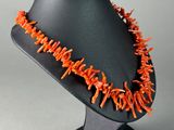 an image of a necklace made out of orange coral coral beads