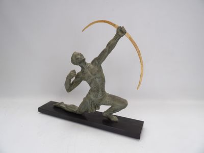 bronze sculpture of a man with a scythe on a black base