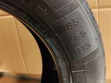a close up of a tire on a wooden surface with a cardboard box in the background