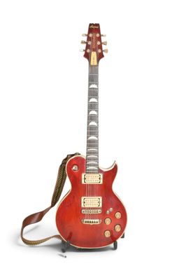 une image représentant une guitare électrique rouge posée sur une surface blanche