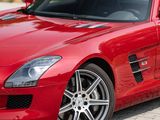 the red mercedes sls is parked on the side of the road