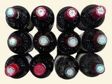 many bottles of wine that are stacked on top of each other