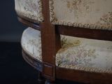 a close up of a chair with a floral upholstered back