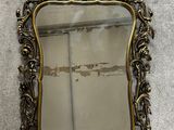 an antique mirror with a gold frame sitting on the floor