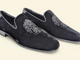 men ' s black velvet slippers with a lion on the front