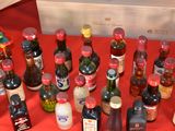 many bottles of alcohol sitting on a red table
