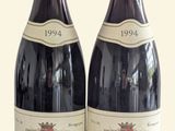 two bottles of wine sitting next to each other on a table