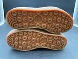 pair of brown shoes with floral design on them sitting on a table