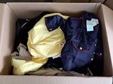 a cardboard box filled with clothes and a yellow shirt