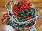 a table with a bunch of necklaces and bracelets on it