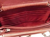 the inside of a red purse with a chain hanging from it