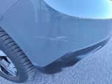 a close up of a car ' s front bumper with scratches