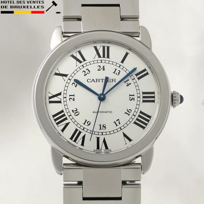 a silver wrist watch with roman numerals on it