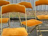 four chairs sitting in a row on the street