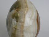 a marble egg with a gold stand on a white surface