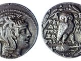 a silver coin with an image of a woman and a bird on it