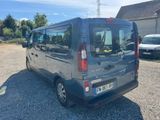 a small grey van parked in a parking lot