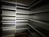 a long shelf in the middle of a dark room