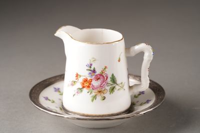 a small cup and saucer on a saucer on a table