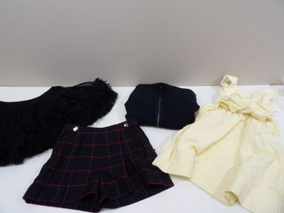 three pieces of clothing are sitting on a table next to a purse
