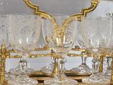 a gold plated wine glass holder on a wooden table