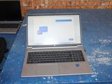 a laptop computer sitting on top of a blue table