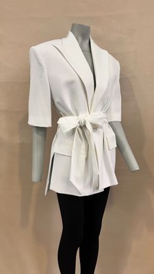 a mannequin wearing a white jacket and black leggings