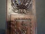 a wooden chair with a carved design on the back