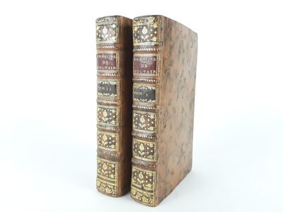 two books that are sitting side by side on a white surface