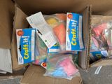 a cardboard box filled with assorted items on the street