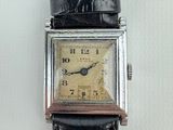 a watch that is sitting on a black strap