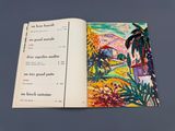 un livre ouvert sur lequel figure l'illustration d'une scène de plage