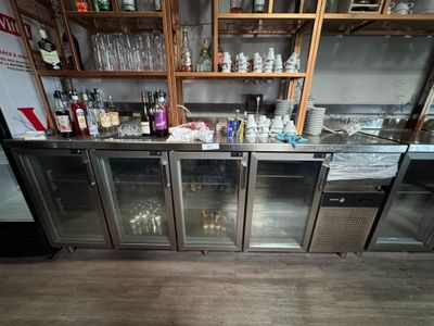 bottles of alcohol are lined up on the shelves of a bar