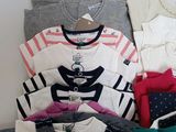 a lot of baby clothes that are on a table