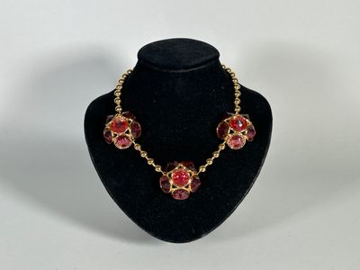 a necklace and earring set on a mannequin display