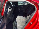 a red car with the door open and the seats down