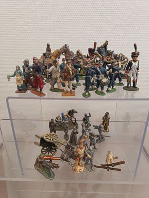 many figurines in a display case on a table