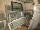 many old windows in the corner of a room