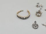 a lot of different rings and earrings on the table